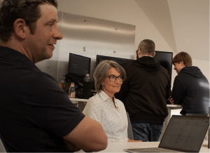 Team meeting around the table with the director and a woman