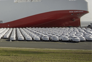 White cars in front of a ferry