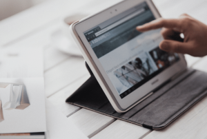 Ipad sitting on a pale wooden table