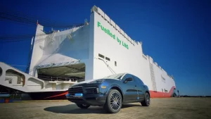 a ship docking next to a blue car