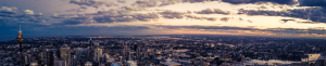 a landscape of the city with the sky in the background in the evening