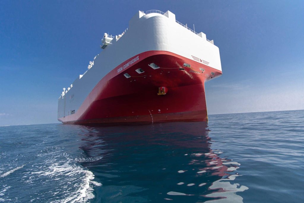 Vehicle carrier ship at port — Bison Grid operates across maritime, road, and rail logistics